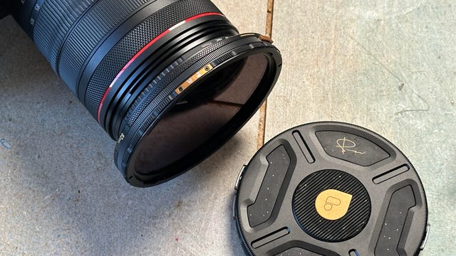 image of a filter on a camera lens with case nearby