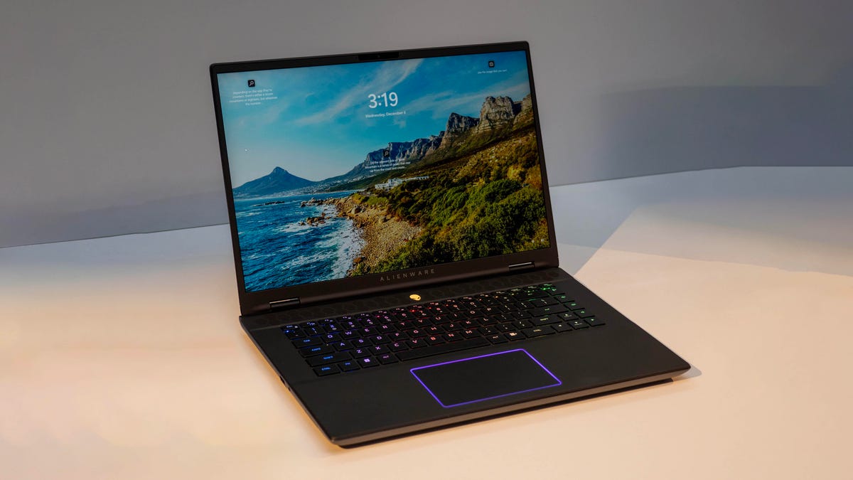 Alienware m16 R2 gaming laptop open facing front sitting on a white desk with a gray background.