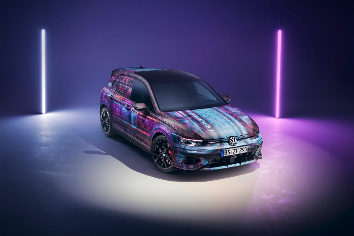 A multicolored VW Golf GTI car on a stage