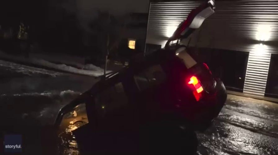 Car plunges into Washington state sinkhole