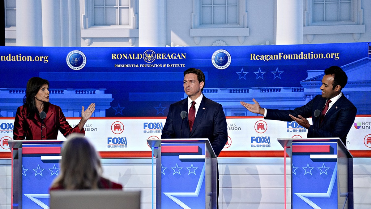 Ron DeSantis, center with Nikki Haley, left and Vivek Ramaswamy right on stage