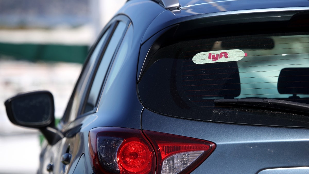 A vheicle with a Lyft sticker on the rear window