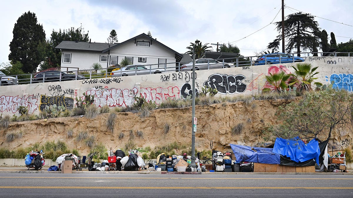 People in tents on a sidewalk