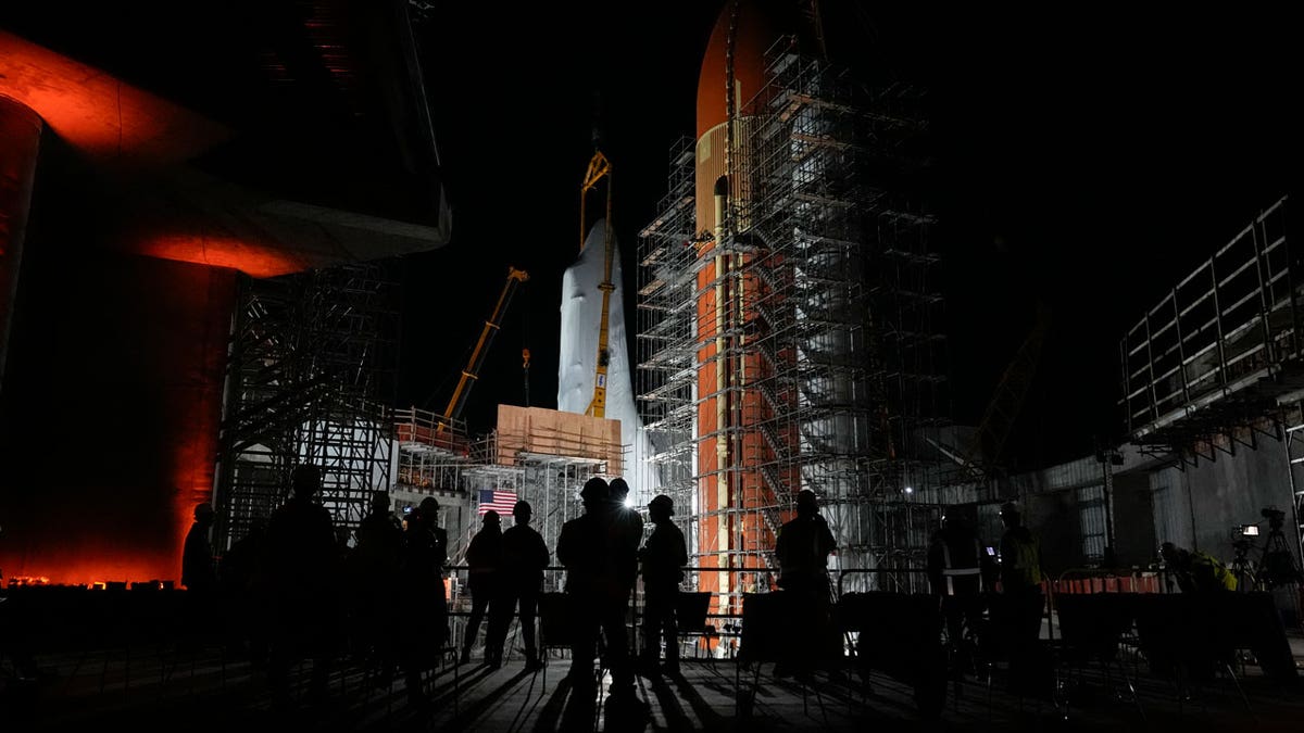 The retired NASA Space Shuttle Endeavor is lifted into the site of the future Samuel Oschin Air and Space Center