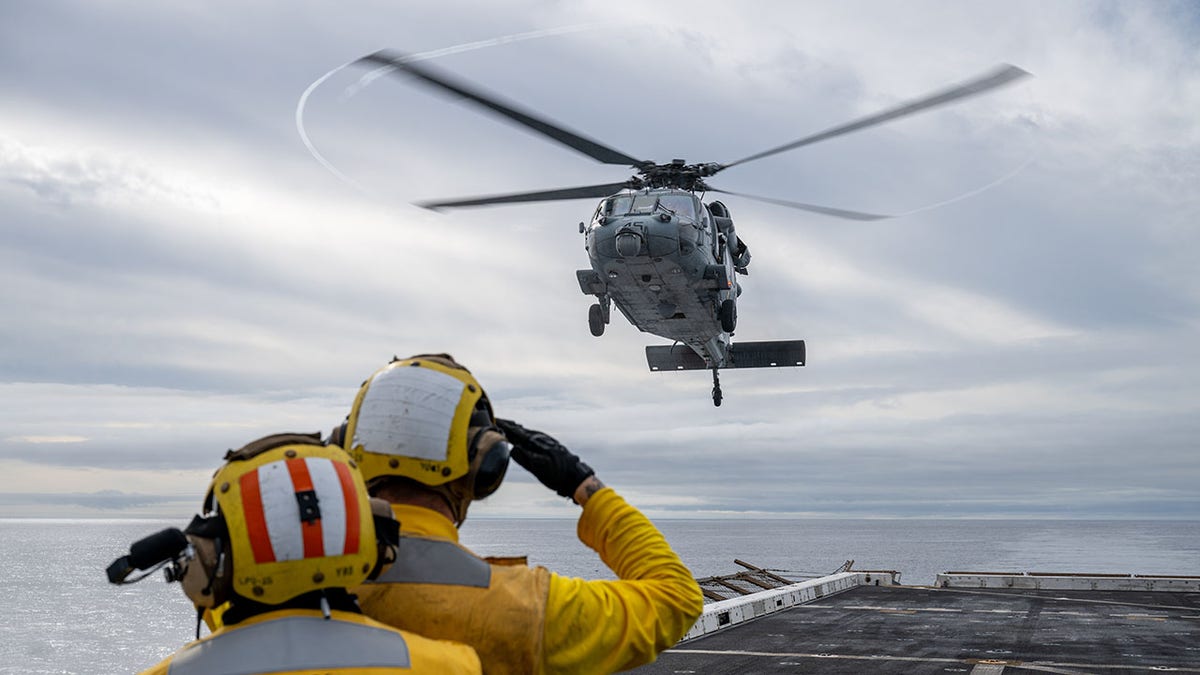 Helicopter, personnel waving