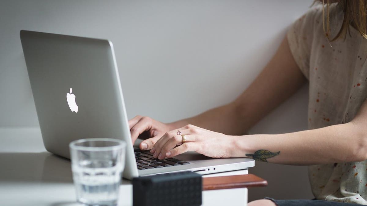 woman typing on a mac