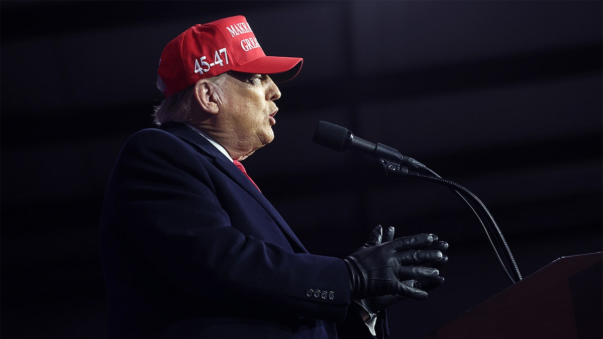 Donald Trump speaks to a crowd from the podium.