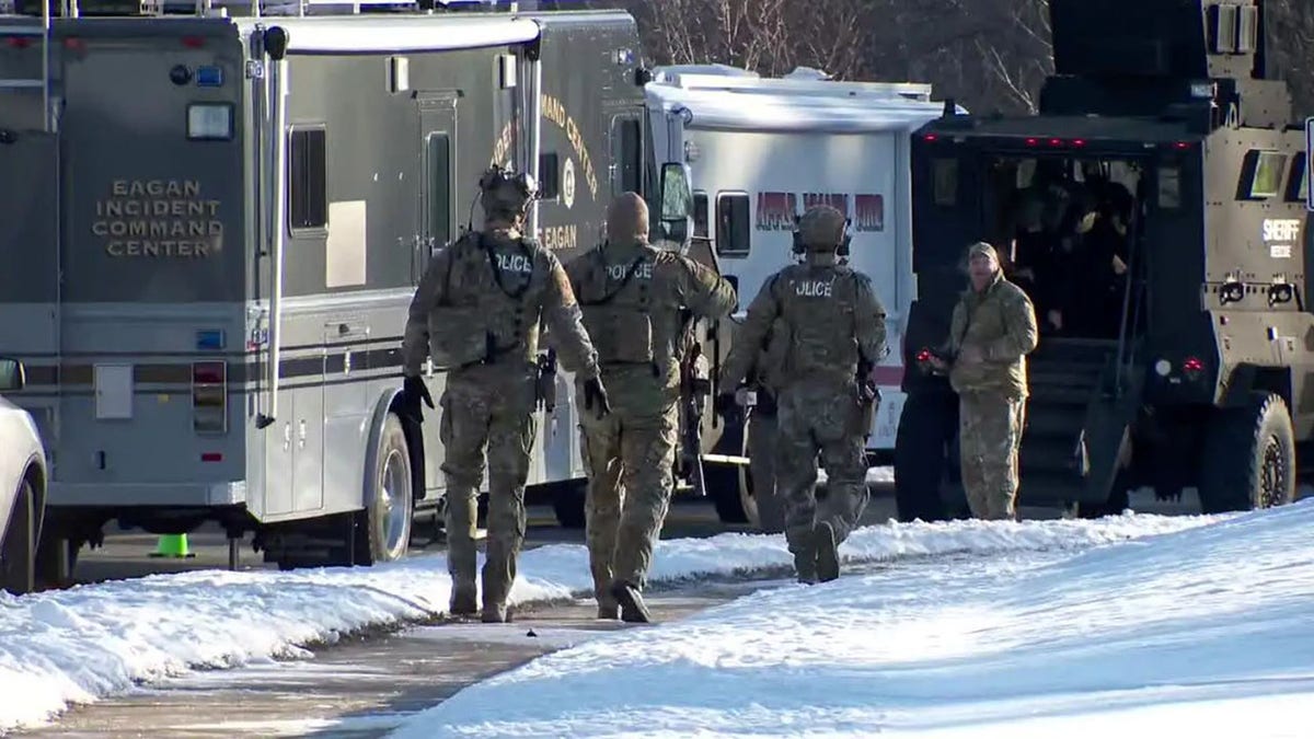 law enforcement walking near emergency vehicles