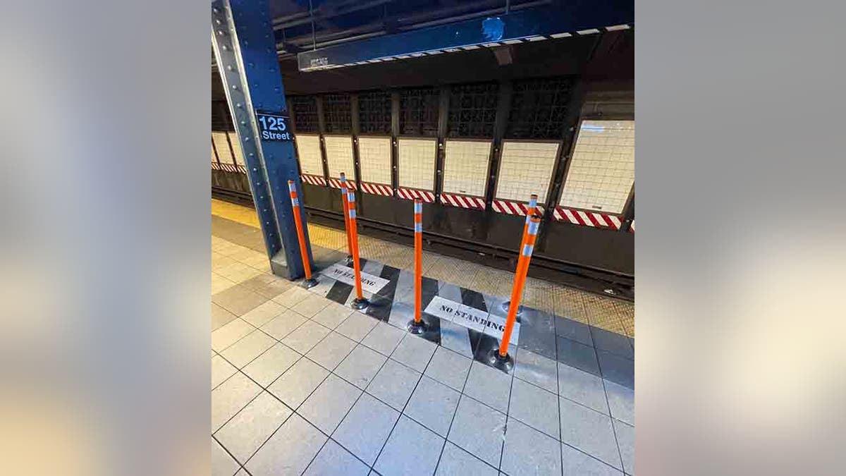 rubber poles around no standing zone on subway platform