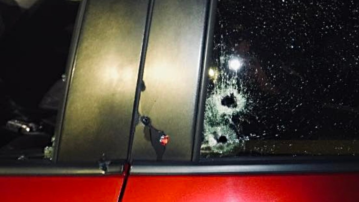 Bullet holes seen on the side of the victim's vehicle.