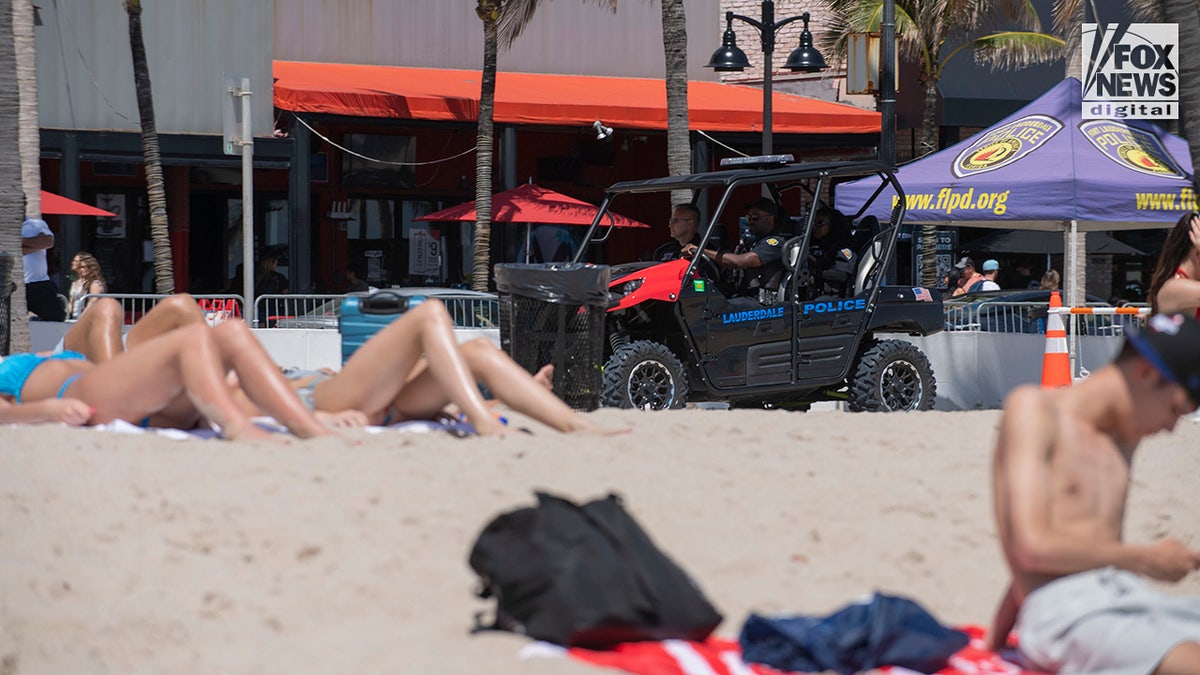 Local police officers patrol as spring breakers enjoy the beach in Fort Lauderdale, Florida