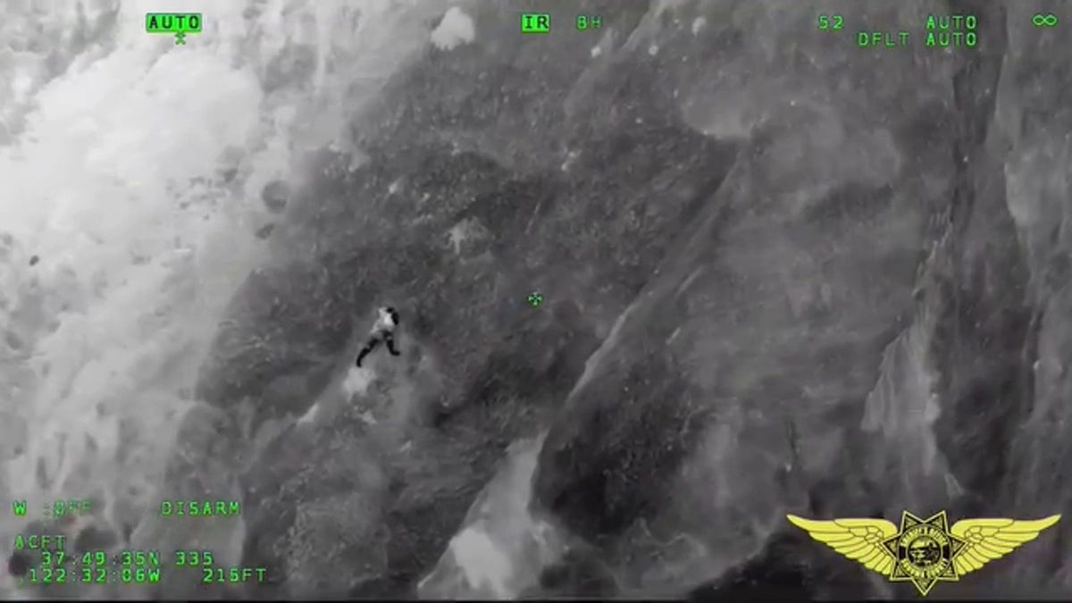 thermal imaging camera image of man of cliff face