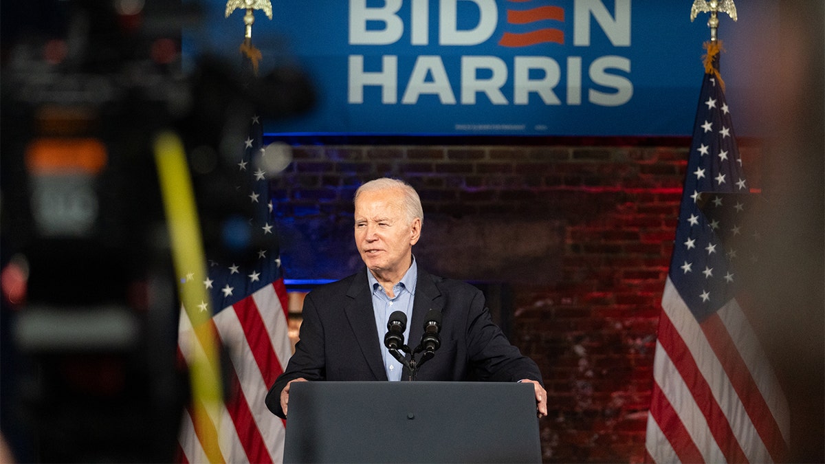 President Joe Biden at podium, flanked by US flags