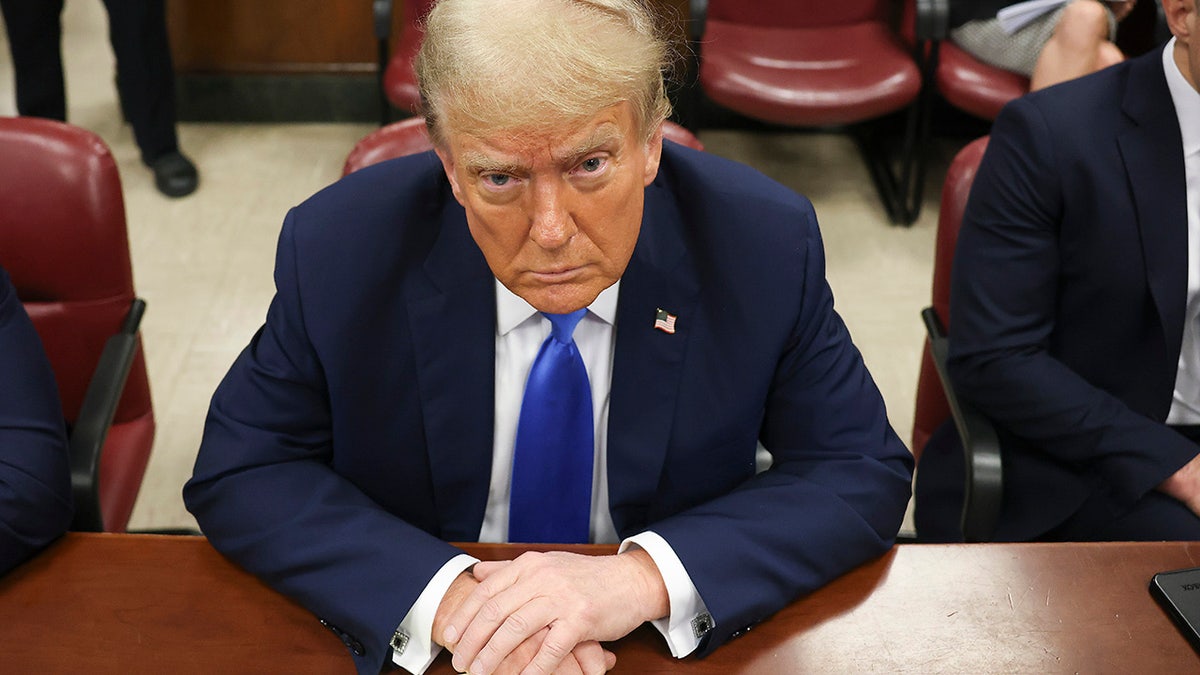 Donald Trump sits in the courtroom for the first day of opening arguments in his Manhattan criminal trial.