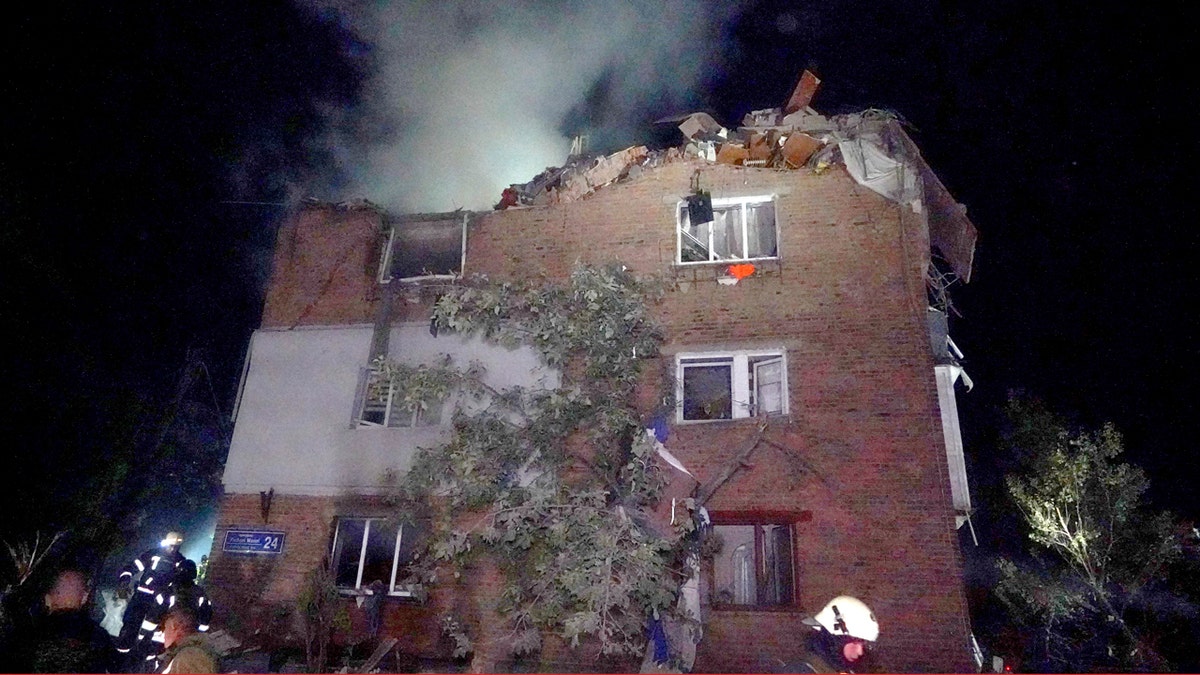 Firefighters put out a fire in a smoking apartment building damaged in a Russian missile attack in Kharkiv, Ukraine.