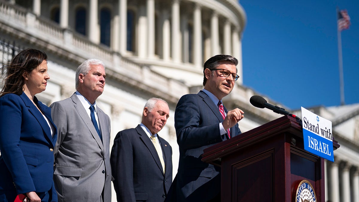 Mike Johnson speaks at a Stand with Israel podium