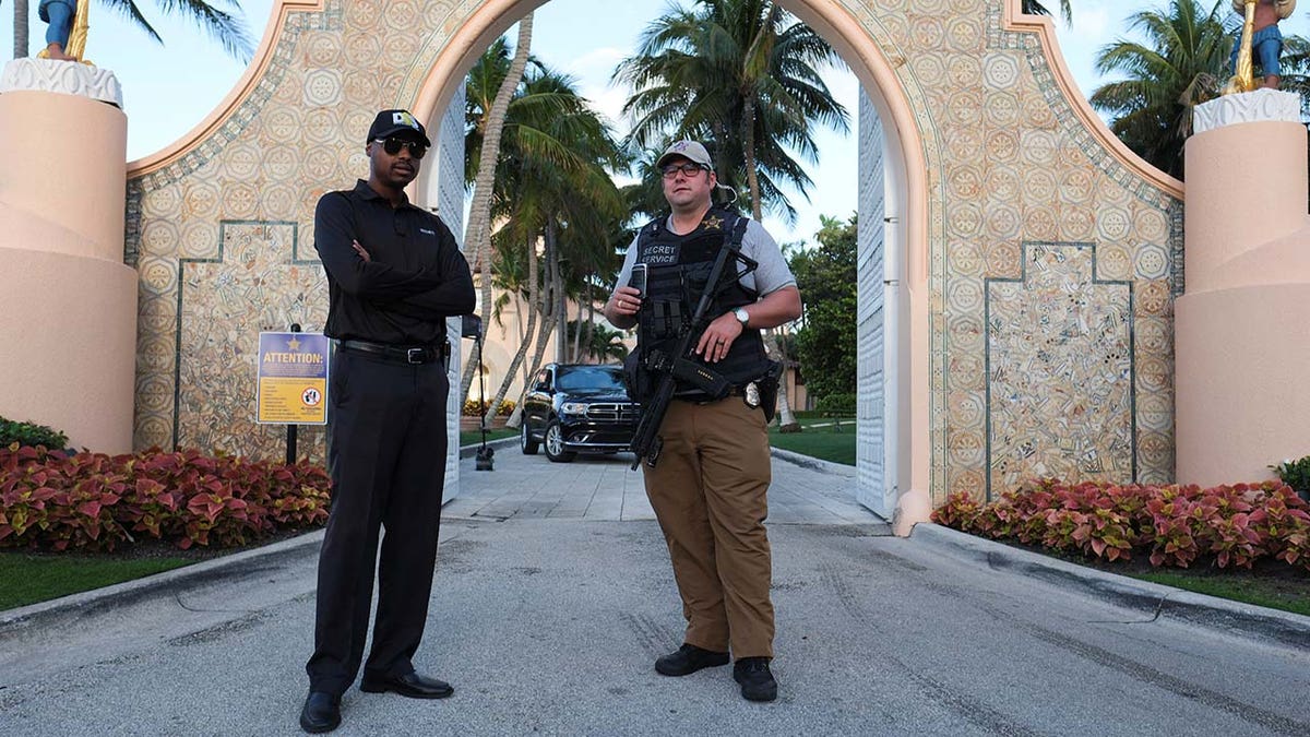 security guard and Secret Service agent at gate outside Mar-a-Lago