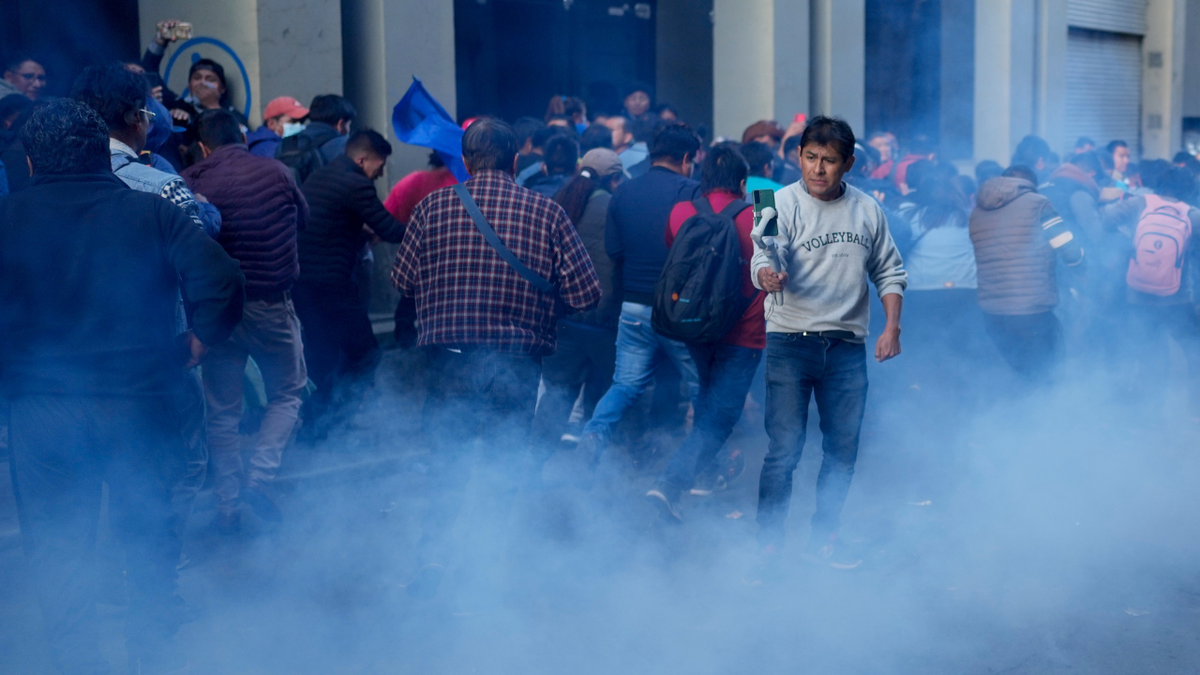 Supporters of Bolivian President Luis Arce enter Plaza Murillo