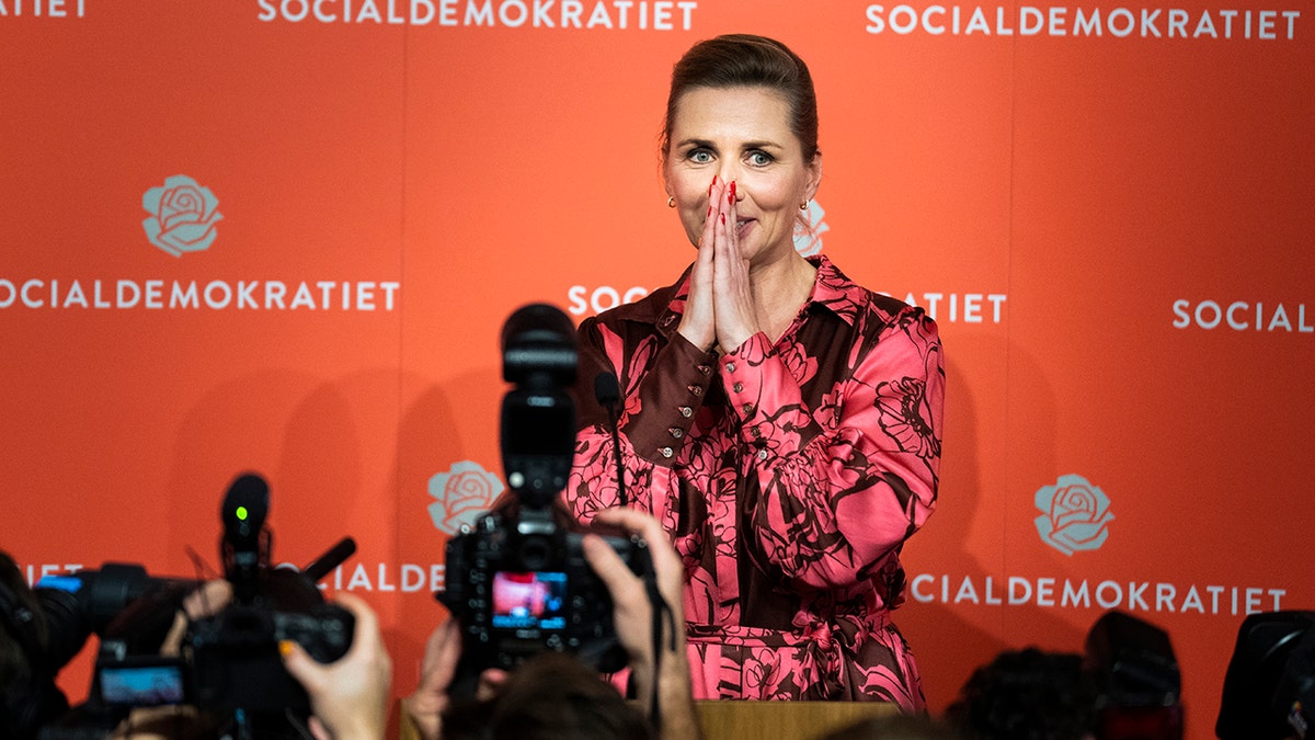 Denmark's PM Mette Frederiksen puts hands over face in shock