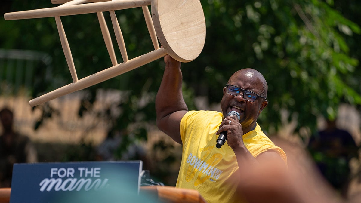 Bowman shakes a stool on stage of Bronx rally 