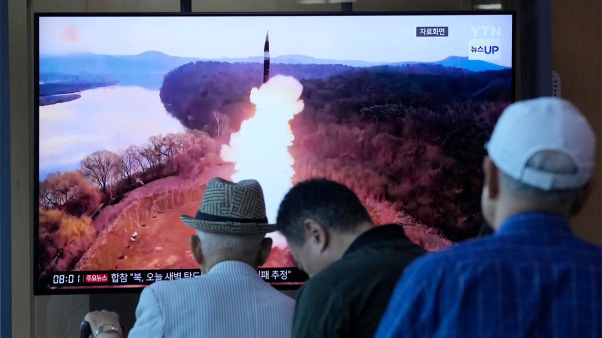 south koreans watch broadcast of missile launch on television