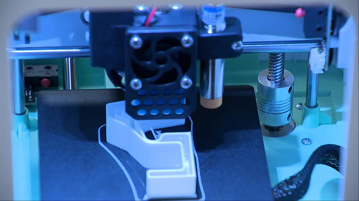 3D printer fabricates a machine gun conversion device.