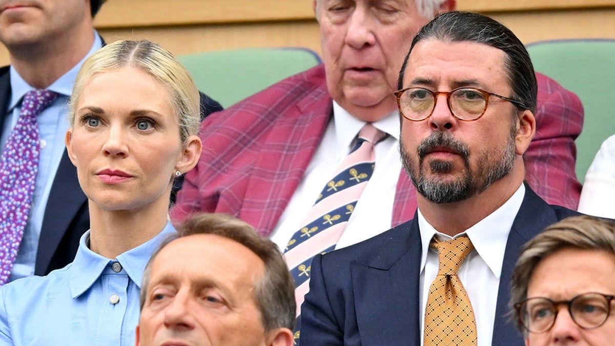 Foo Fighters singer Dave Grohl wears blue suit to Wimbledon with wife Jordyn Blum.