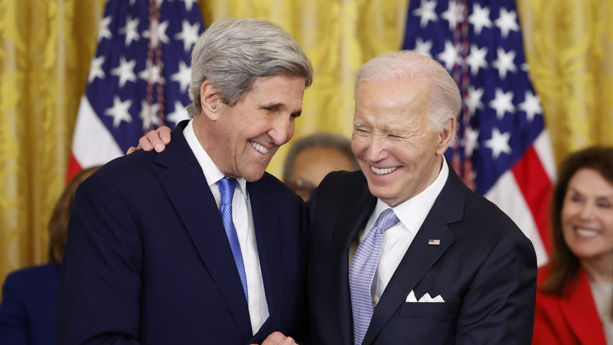 John Kerry (R) and President Joe Biden (L)