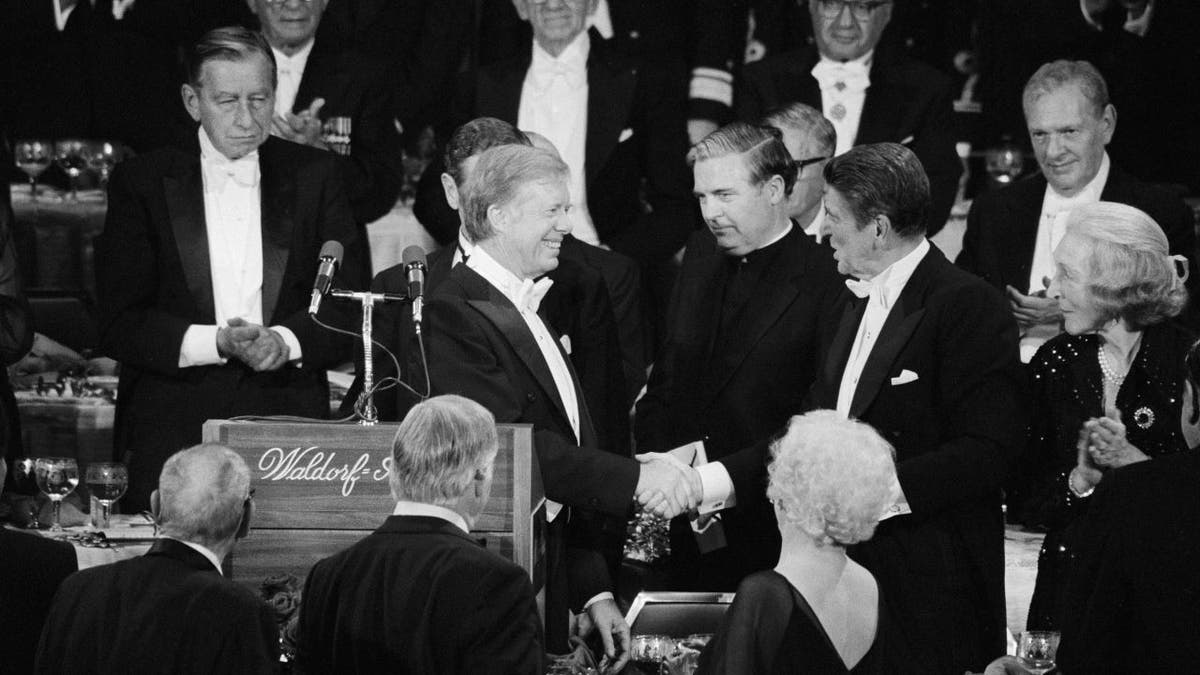 Carter shaking Reagan's hand