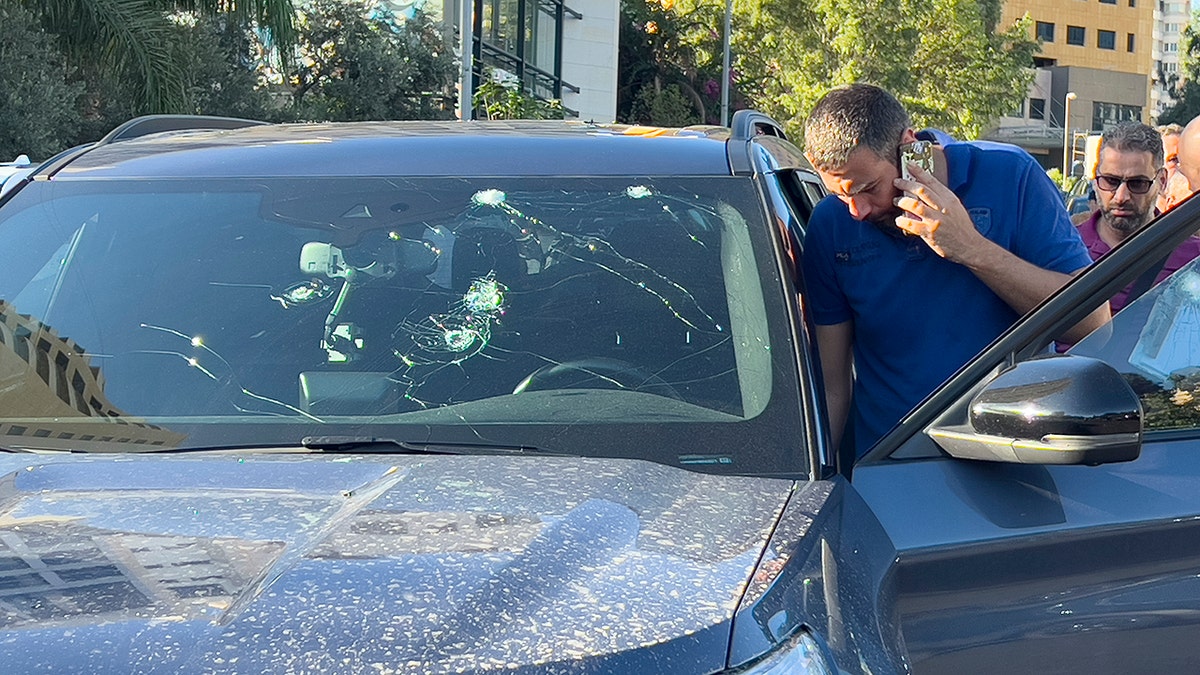 Police officers inspect car