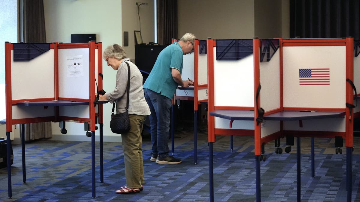 Voters fill out their ballots at a polling station during Massachusetts state primary voting on Tuesday.