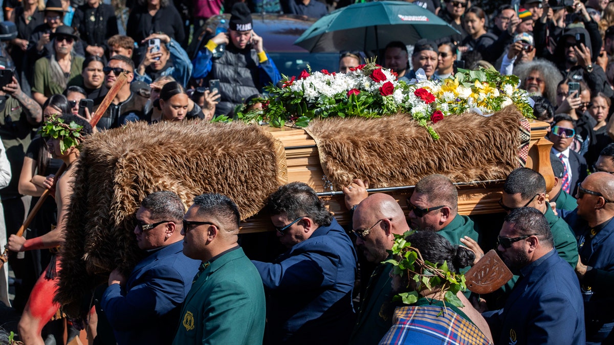 The dead Maori King is carried in a coffin for burial.