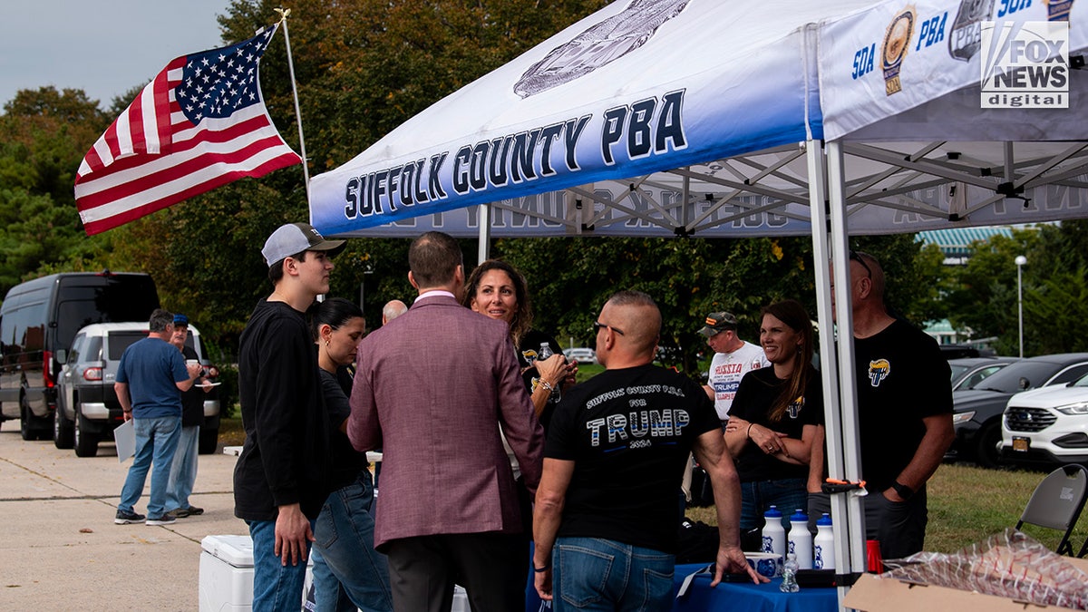 Members of the Suffolk County PBA attend a tailgate ahead of former President Donald Trump’s rally in Uniondale, New York