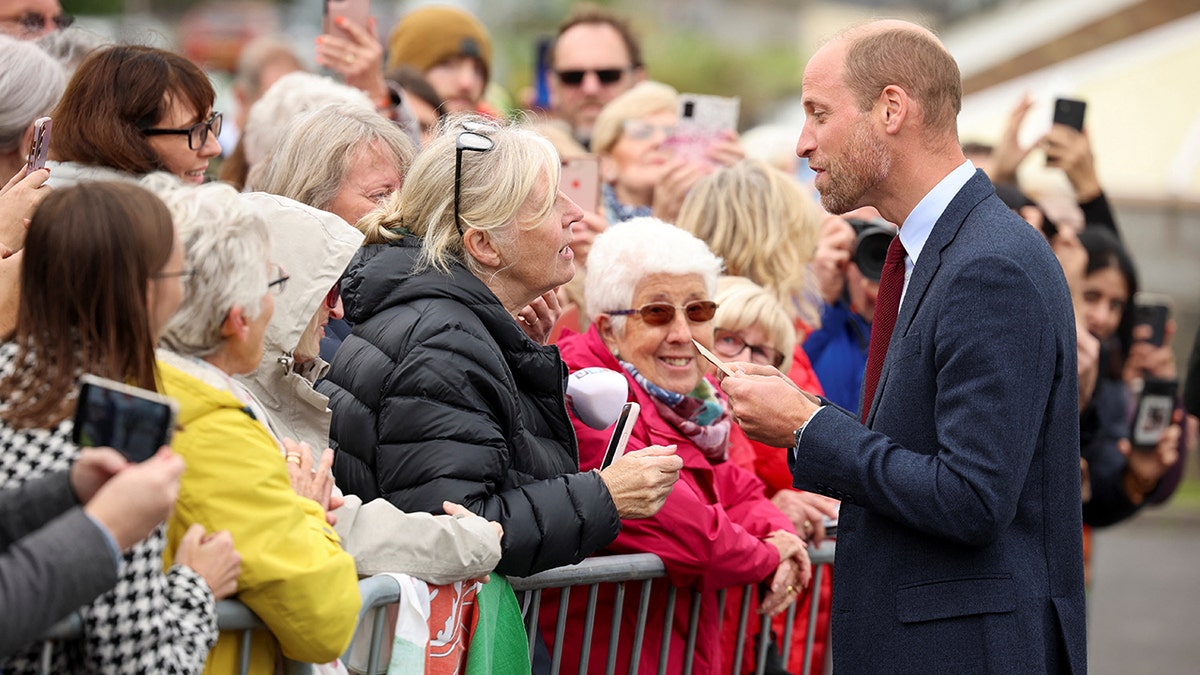 A photo of Prince William speaking to the public