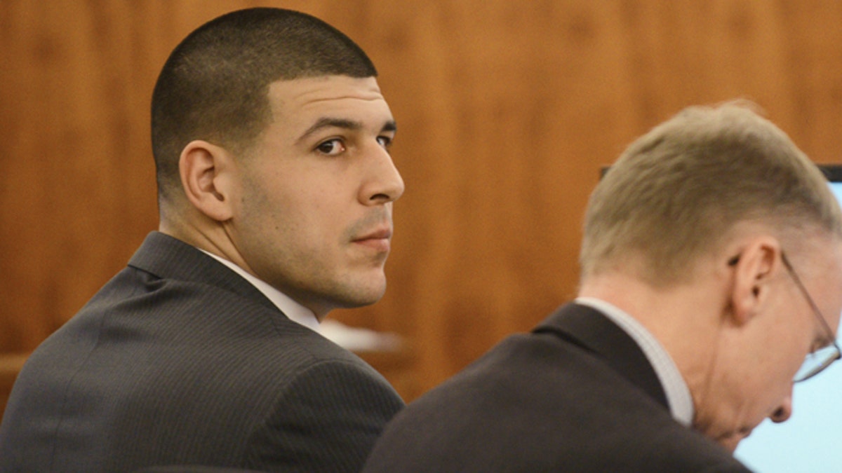 Aaron Hernandez, left, sits with his attorney Charles Rankin during his trial at Bristol Superior Court on Wednesday, Feb. 11, 2015 in Fall River, Mass. Hernandez is charged with killing semiprofessional football player Odin Lloyd, 27, in June 2013. (AP Photo/The Boston Herald, Ted Fitzgerald, Pool)