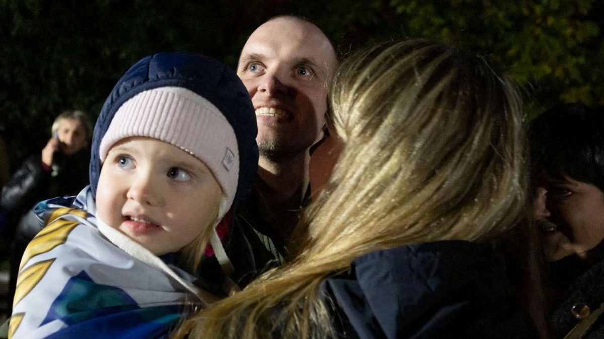 A Ukrainian prisoner of war (POW) stands with his relatives after a swap, amid Russia's attack on Ukraine, in an undisclosed location in Ukraine, in this handout picture obtained on Oct. 19, 2024. 