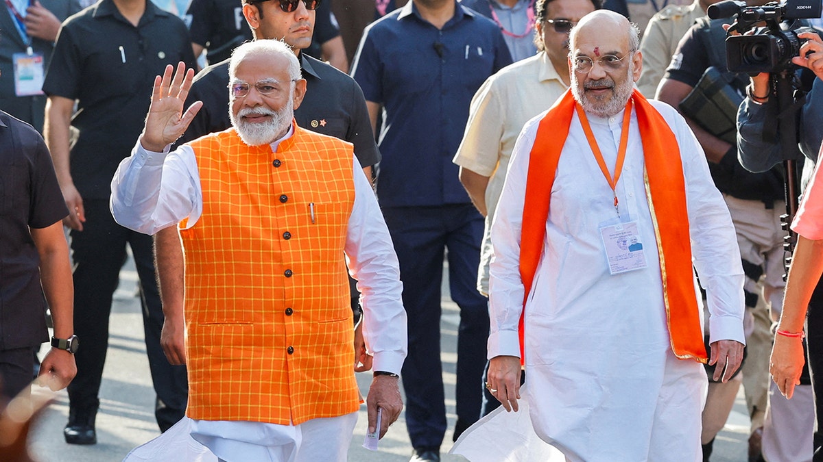 FILE PHOTO: Indias Prime Minister Narendra Modi (L) walks alongside Amit Shah, Indian Home Minister