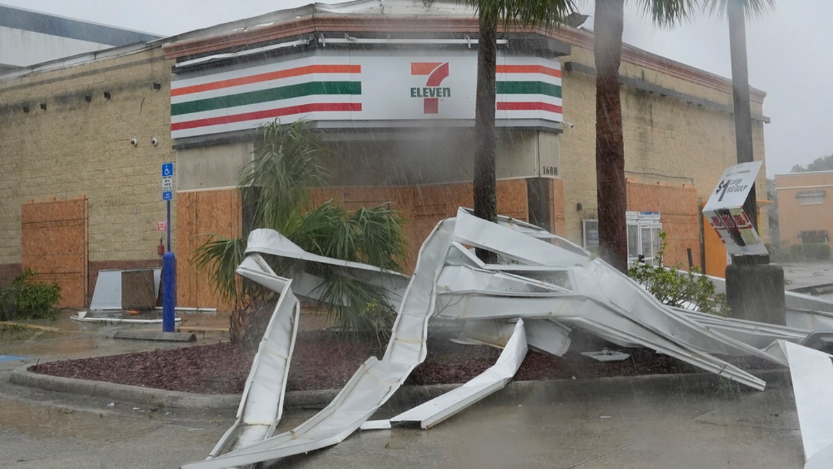 An apparent tornado caused by Hurricane Milton tore the awning off a 7-Eleven convenience store, in Cape Coral, Fla., Wednesday.