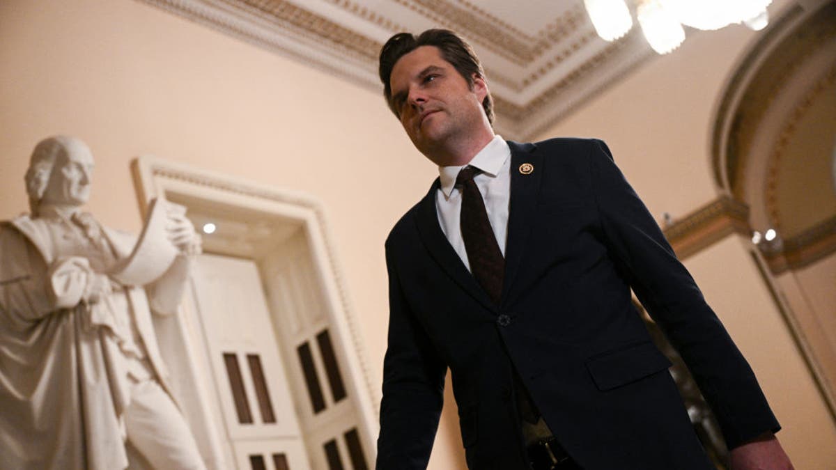 Matt Gaetz walking in Statuary Hall in Capitol