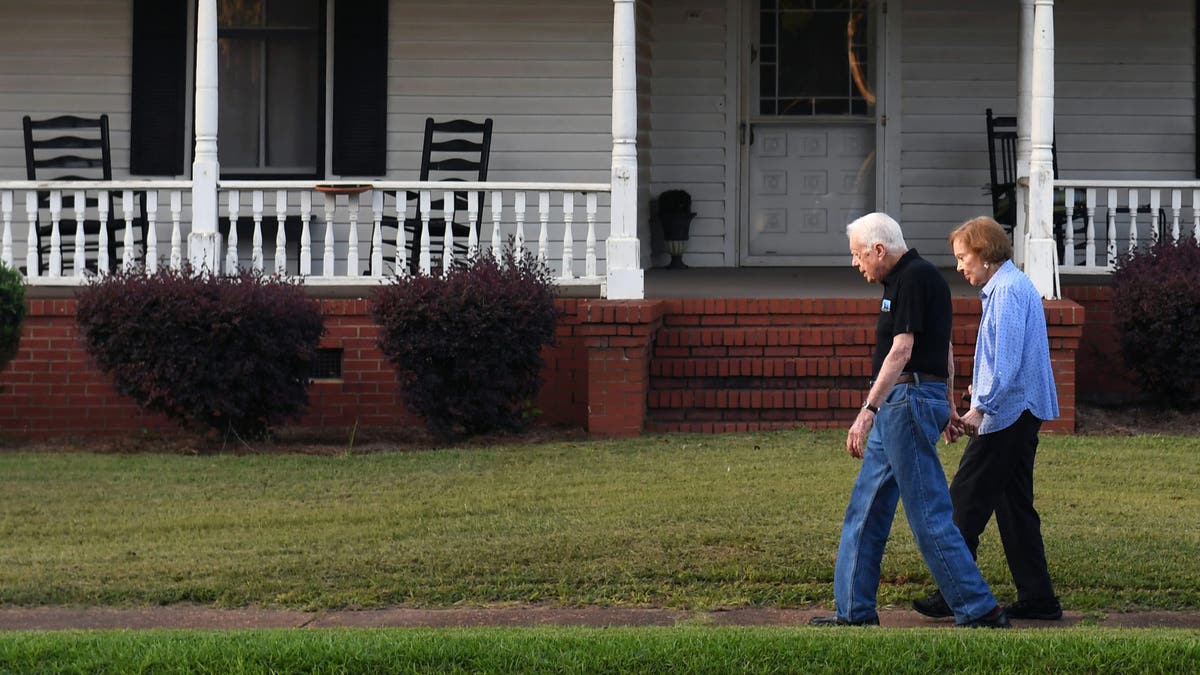 Former President Carter and wife Rosalynn are shown on a walk in their hometown of Plains, Georgia.