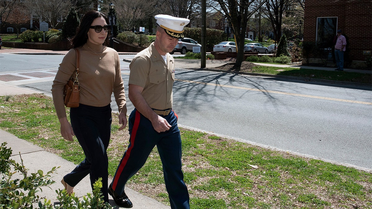 Marine Maj. Mast walking to court with his wife.