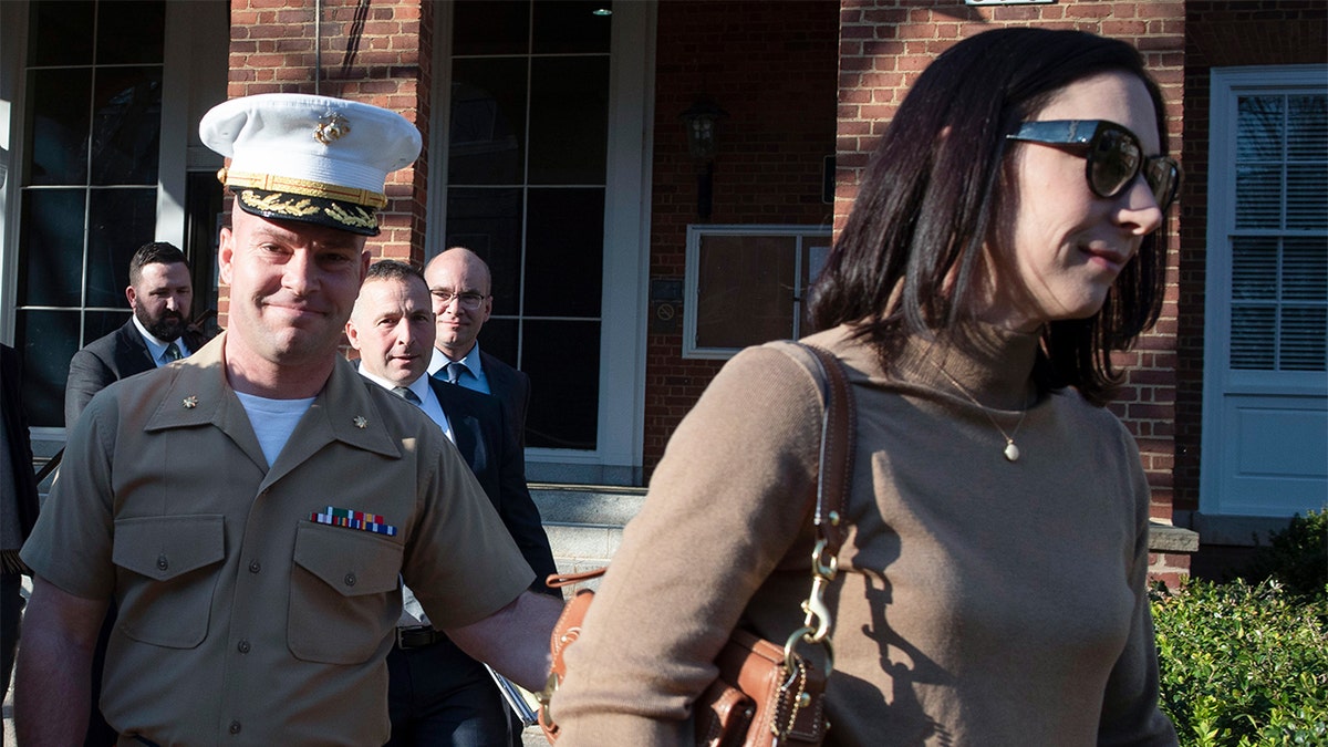 Marine Maj. Mast walking out of court with his wife.