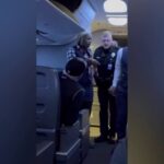 Passengers intervene on flight when man allegedly attacks woman next to him, video shows