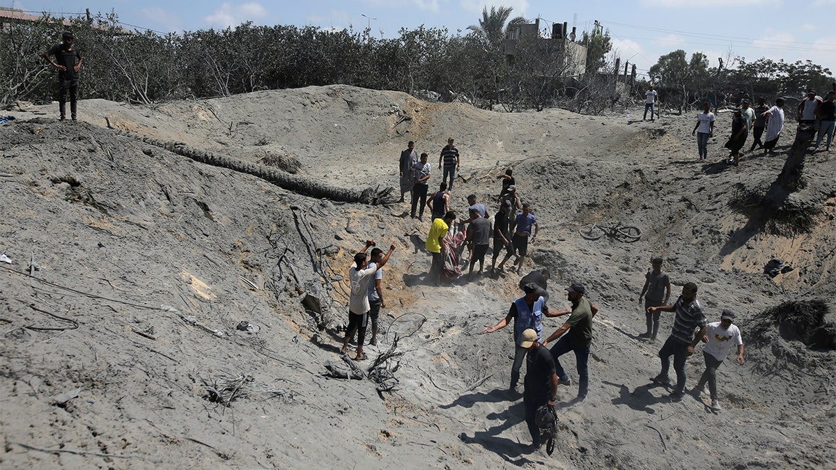 Palestinians searching through rubble