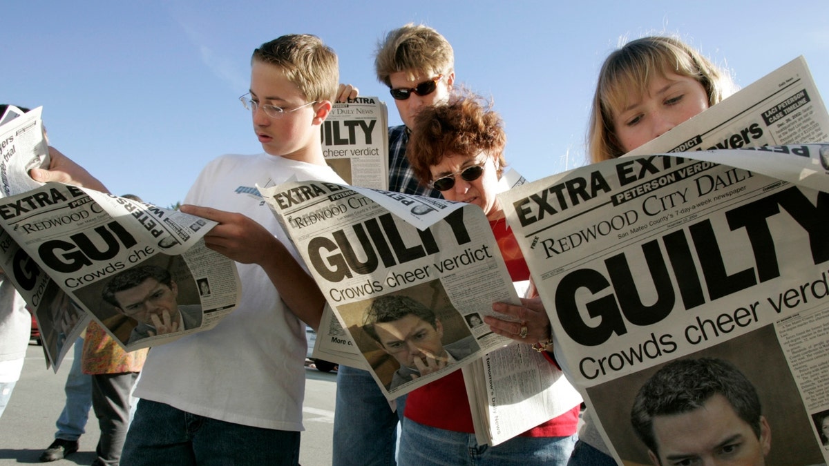 From left: Danny Lewin, 12, Geoff Shenk, Katherine Lewin, and Katie Lewin, 12, read Extra edition put out by the Redwood City Daily News after the verdict in the Scott Peterson trial in Redwood City, Calif, Wednesday November 12, 2004.