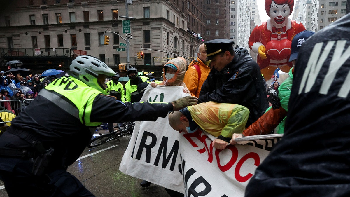 Police officers clash with protesters