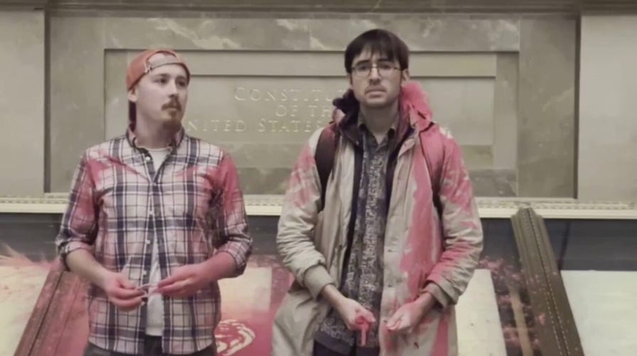 National Archives Rotunda evacuated after climate activists dump pink powder on case holding US Constitution