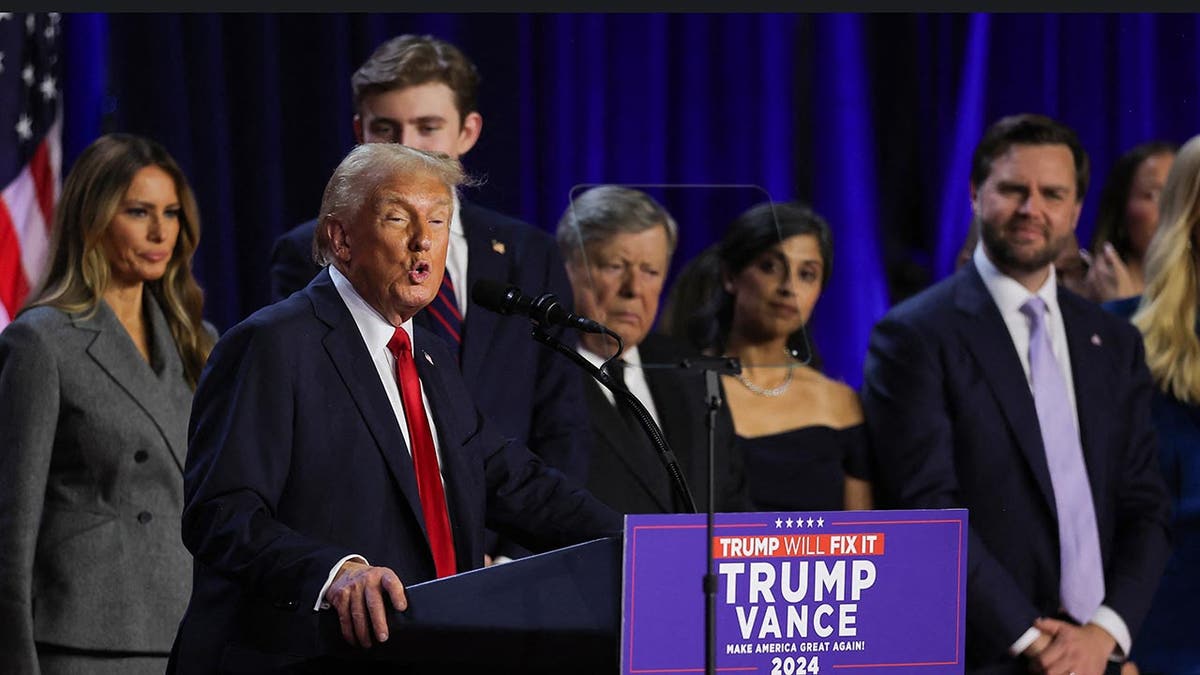 Former President Donald Trump speaks accompanied by Melania Trump, Barron Trump, Vice Presidential Nominee Senator JD Vance, Usha Chilukuri Vance, and Ivanka Trump, following early results from the 2024 U.S. presidential election in Palm Beach County Convention Center, in West Palm Beach, Florida, Nov. 6, 2024.