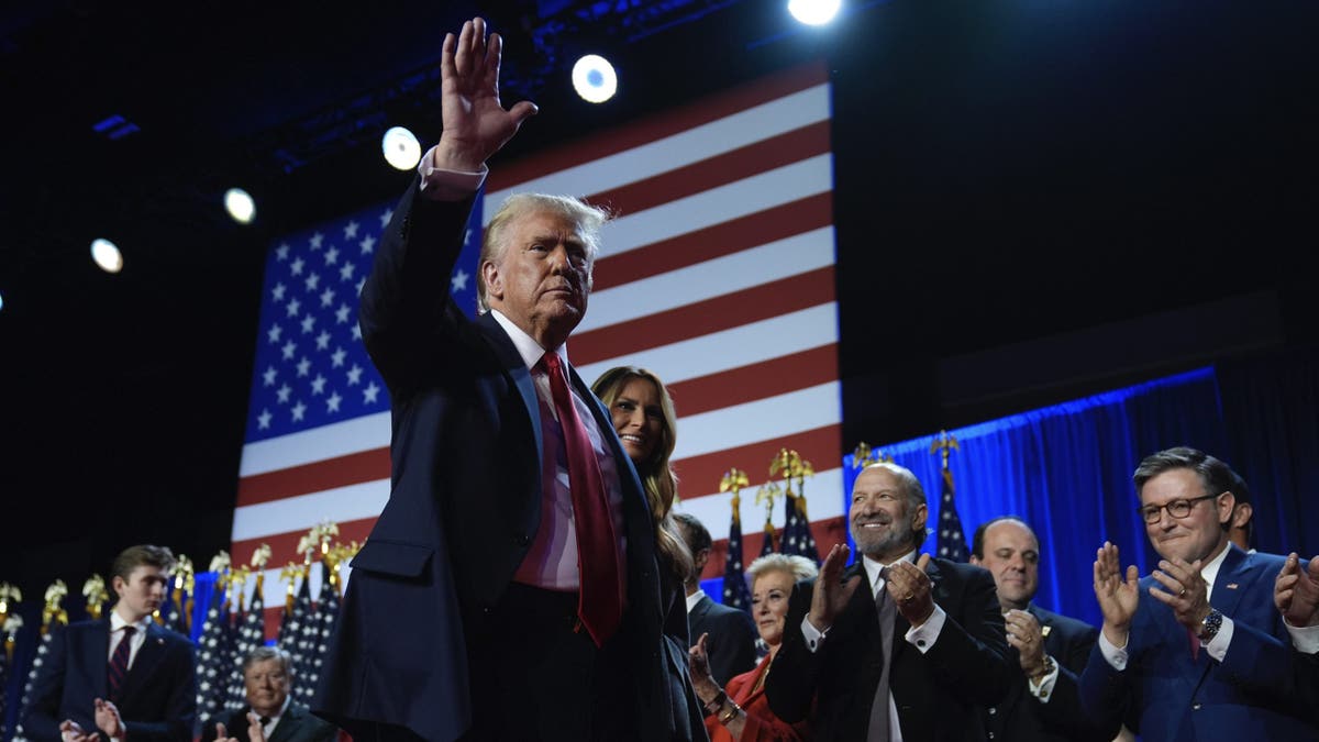 Republican presidential nominee former President Donald Trump and former first lady Melania Trump walk on stage at an election night watch party at the Palm Beach Convention Center, Wednesday, Nov. 6, 2024, in West Palm Beach, Fla. (AP Photo/Evan Vucci)