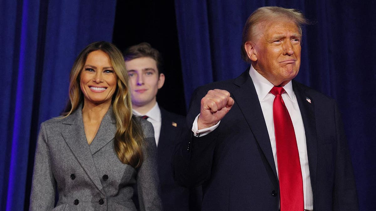 Former President Donald Trump takes the stage with his wife Melania and son Barron to address supporters at his rally, at the Palm Beach County Convention Center in West Palm Beach, Florida, Nov. 6, 2024.